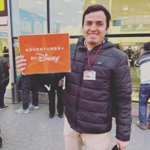 Guide holding sign showing adventures by Disney